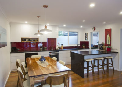 white-gloss-vinyl-spotted gum-polished floors-vanilla noir-kitchen-update-blood pearl-splashback-white pendants