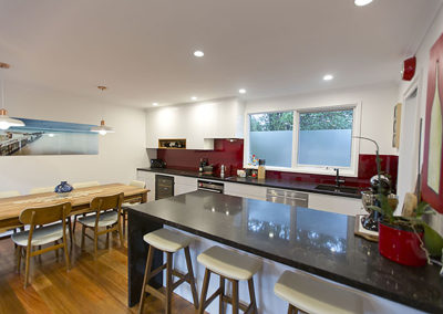 white-gloss-vinyl-spotted gum-polished floors-vanilla noir-kitchen-update-blood pearl-splashback-white pendants-breakfast bar